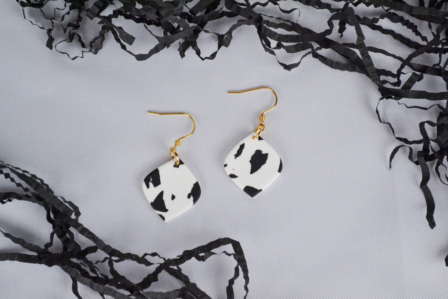 Mae earrings with cow print